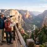 Retired couple in hiking gear at a wooden canyon overlook, the man pointing toward a river valley while the woman holds a map